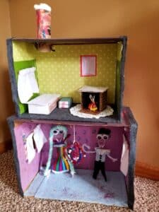 handmade dollhouse with two levels. showing bedroom and ballroom, furnishings and dolls.