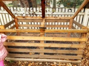 Homemade compost bin made from wood and chicken wire