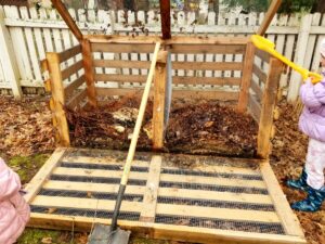 Homemade wooden compost bin.