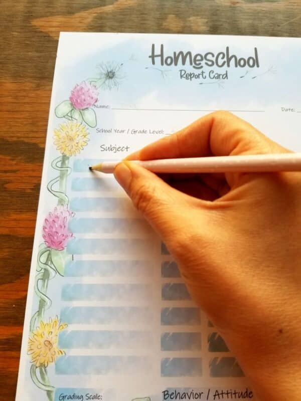 grade card for homeschoolers with hand illustrated flowers along the side. clovers and dandelions.