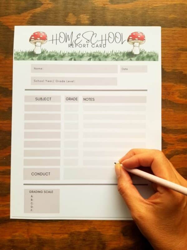 Printable homeschool report card with hand illustrated mushrooms. Grade card has brown accenting throughout and includes spaces to fill in subject, grades, notes, grading scale, and behavior notes.