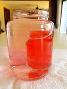 science experiment showing cold water staying in small jar for second variation of experiment