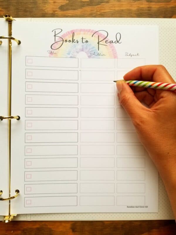 Homeschool planner includes books to read page. Hand illustrated rainbow theme throughout the planner.