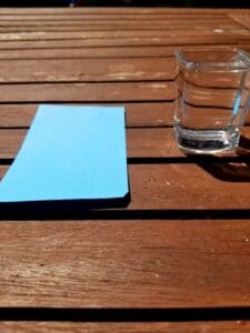 Supplies needed for this science experiment are a glass of water filled to the brim and an index card.