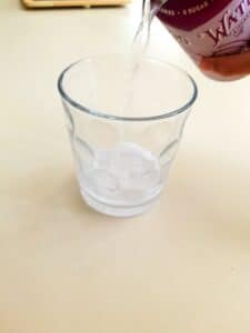 Pour carbonated beverage into a glass for this experiment.