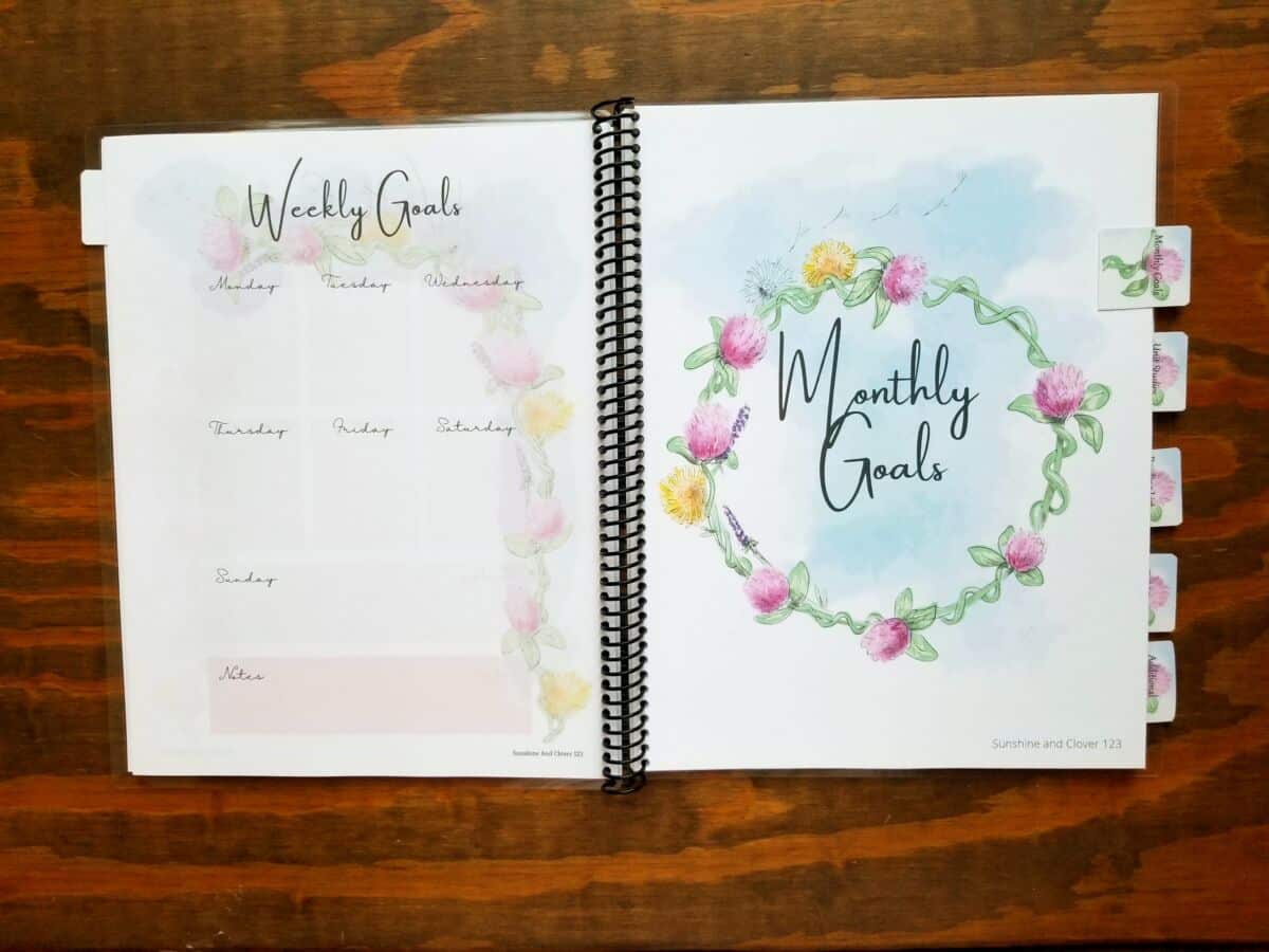 Spiral bound homeschool planner that has hand illustrated flower theme. This homeschool planner has a flower theme throughout all the pages with soft pink accenting. Dividers are provided between sections and have matching flower theme along with flower tabs for easy reference.