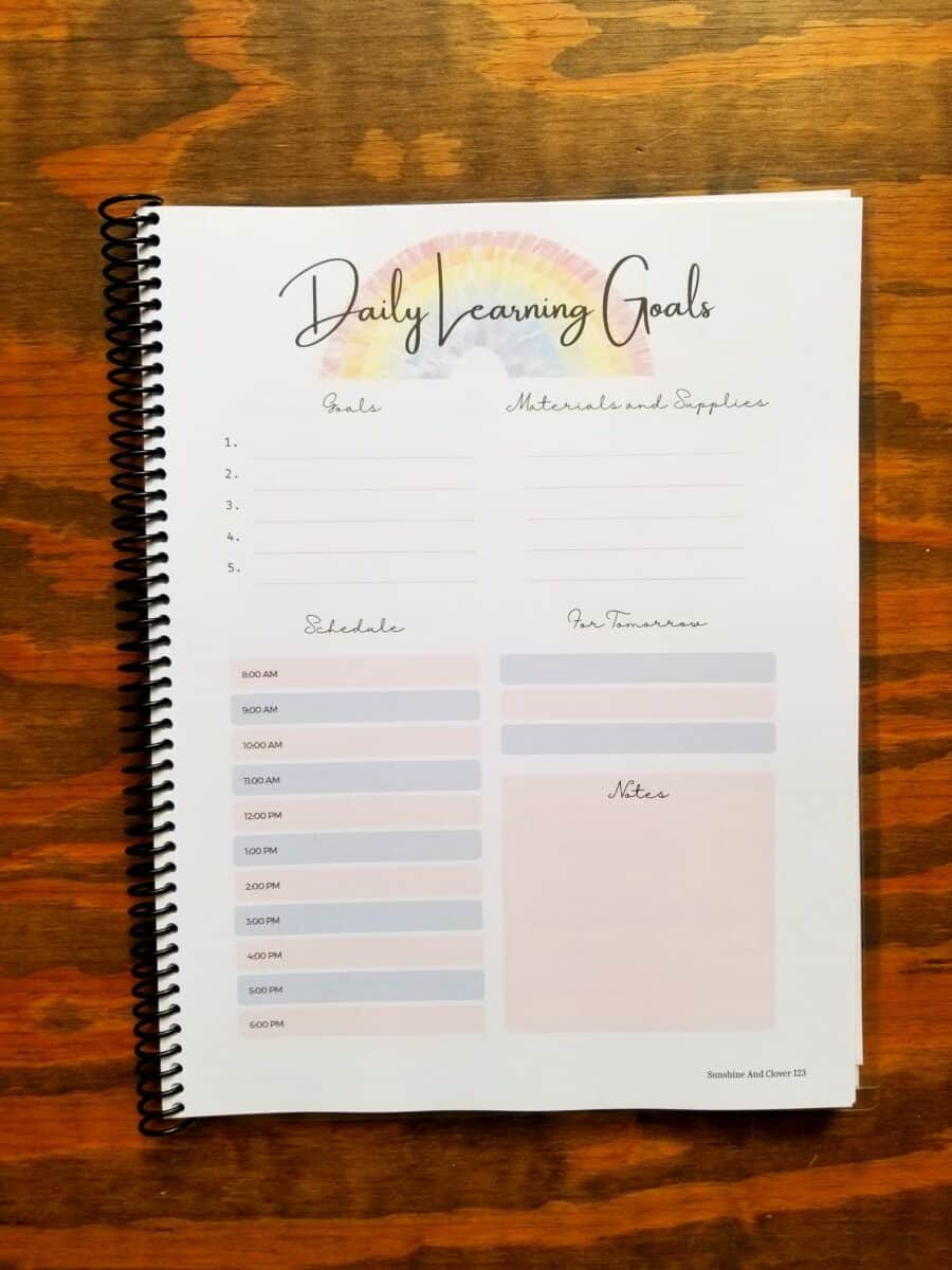 Rainbow themed homeschool planner for daily planning. Get your homeschool days organized with this homeschool planner that has hand illustrate rainbows at the top with soft pink and blue accenting throughout. Includes hourley schedule, goals, notes, materials list, and for tomorrow sections.