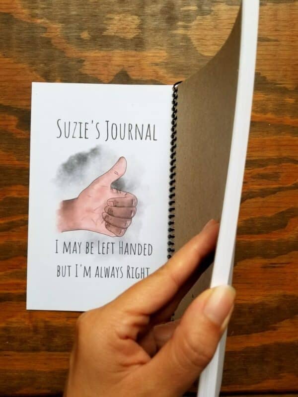Left handed notebook contains 50 pages of high quality 32 pound pages. Customize the notebook title and choose between light and dark skin tones on hand illustrated thumbs up hand.