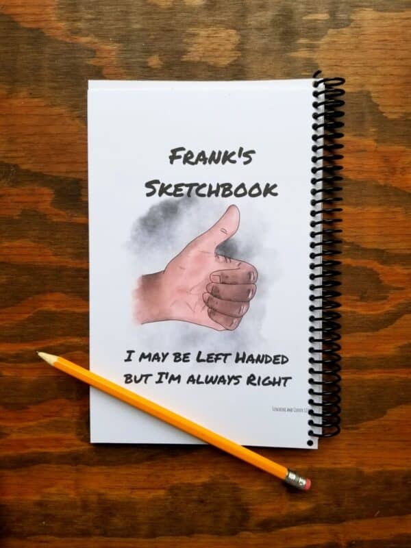 Personalized sketchbook cover for left handers. Hand illustrated thumbs up design with high quality blank pages in the notebook.