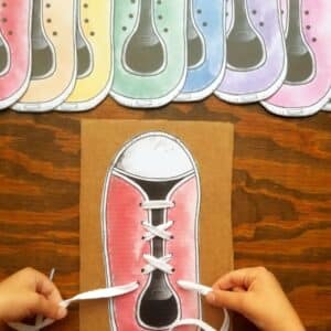 Montessori preschool printables for learning how to tie shoe laces shown cut out and ready to be glued onto cardboard then laced to practice tying shoes.