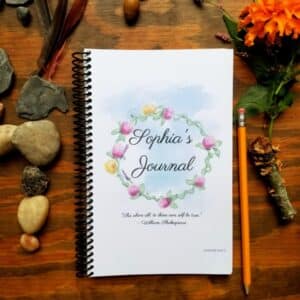 Personalized spiral bound notebook includes hand illustrated flower design and customization of font and text on the journal cover. Cursive style writing featured on this cover option.