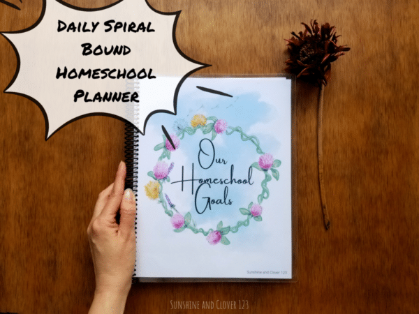 Daily spiral bound homeschool planner contains daily planning pages for hourly planning in your homeschool days. Homeschool planner has a hand illustrated flower ring encircling the title "Our Homeschool Goals."