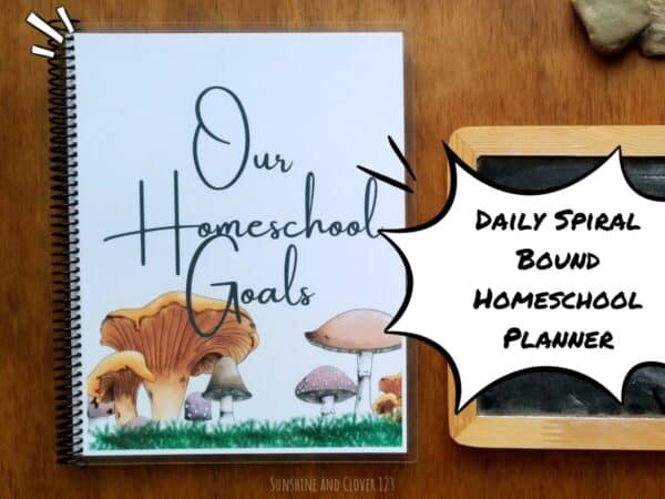 Daily homeschool planner for scheduling down to the hours. Planner is spiral bound and has hand illustrated woodland mushroom designs set in moss on the front cover with title "Our Homeschool Goals."