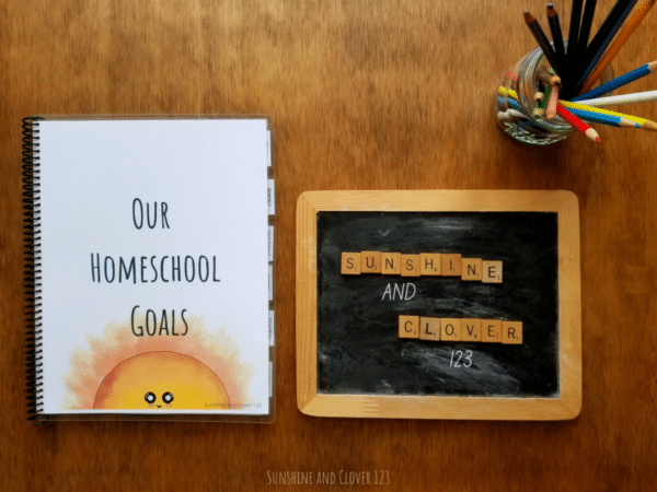 Planner for homeschoolers comes in a hand illustrated kawaii style with a smiling sunshine on the front cover and title reading "Our Homeschool Goals."