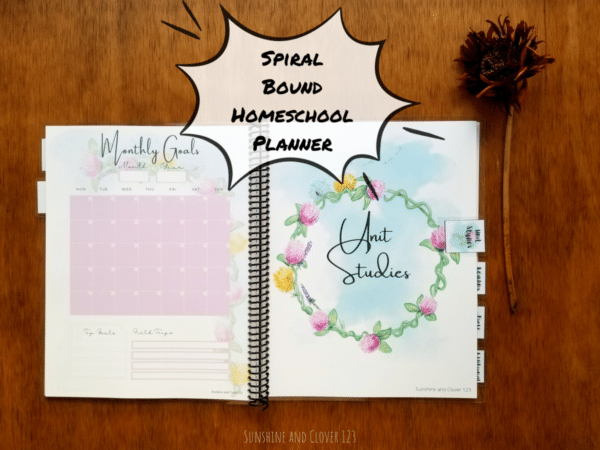 Spiral bound homeschool planner with hand illustrated flower design throughout the planner. Unit studies section and the monthly undated calendar is pictured.