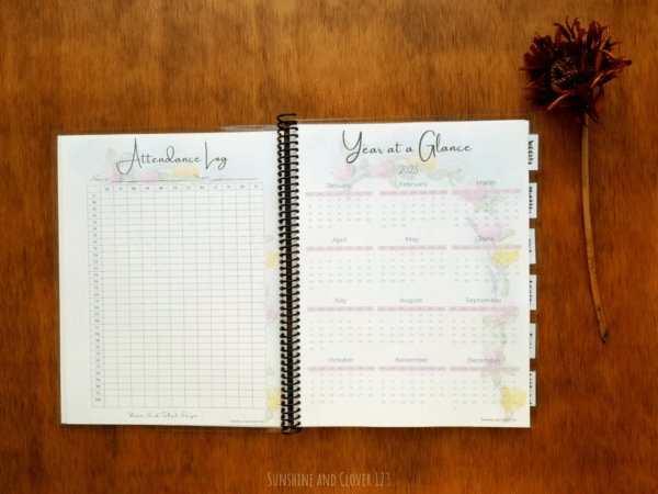 Spiral bound homeschool planner includes an attendance log and year at a glance pages. All pages have a matching flower theme.