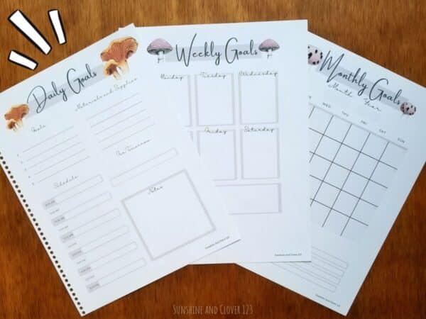 Homeschool planner contains daily planning pages, weekly planning pages, and monthly planning pages. Pages have a mushroom theme with multiple hand illustrated mushrooms along the top of the page.