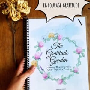 Prompted gratitude journal is titled the gratitude garden and has a hand illustrated flower circle encircling the title. Journal pages are shown printed out and spiral bound in US standard size paper.