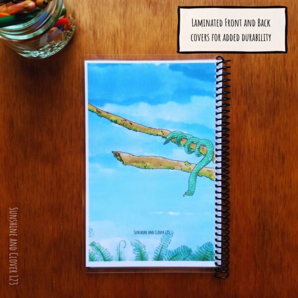 Zoo journal for kids is laminated on the front and back covers for added durability on your next field trip to the zoo. Back cover has a snake hanging from a branch with ferns below and a blue sky background.