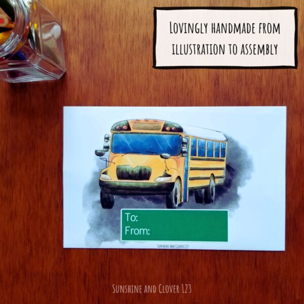Gift card holder for school bus drivers is lovingly handmade from illustration to assembly. Gift card holder for school bus drivers. Hand illustrated school bus with white background and green street sign below to personalize.