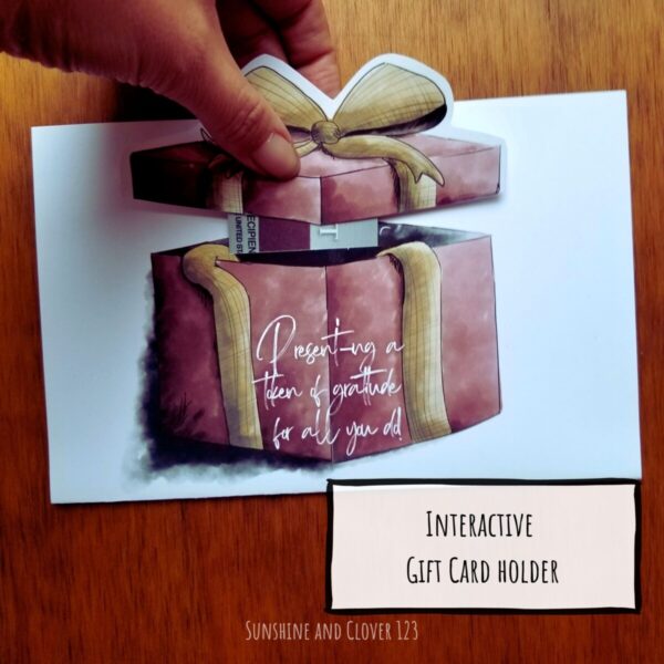 Gift card holder comes in a hand illustrated present theme. Card features a red gift box with beige ribbon wrapped around. Gift card holder is hiding under the box top and can be removed to reveal gift card.