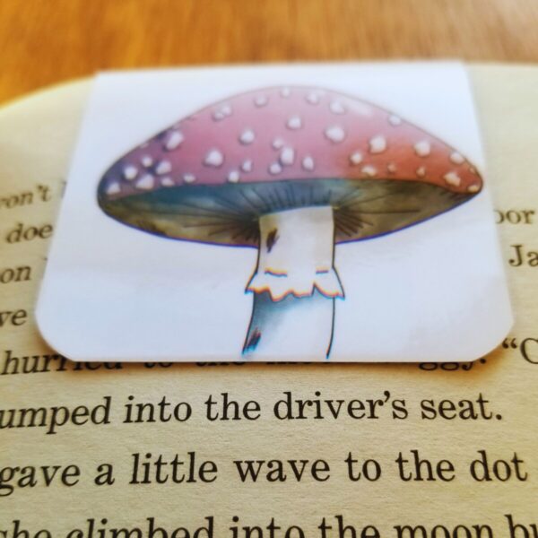Mushroom bookmark is laminated and shown attached to a paperback book page.