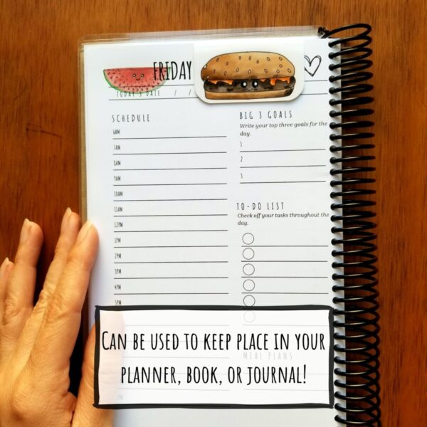 Magnetic bookmark can be used to keep place in your planner, novel, or journal. Cheeseburger bookmark is shown keeping place in a planner.
