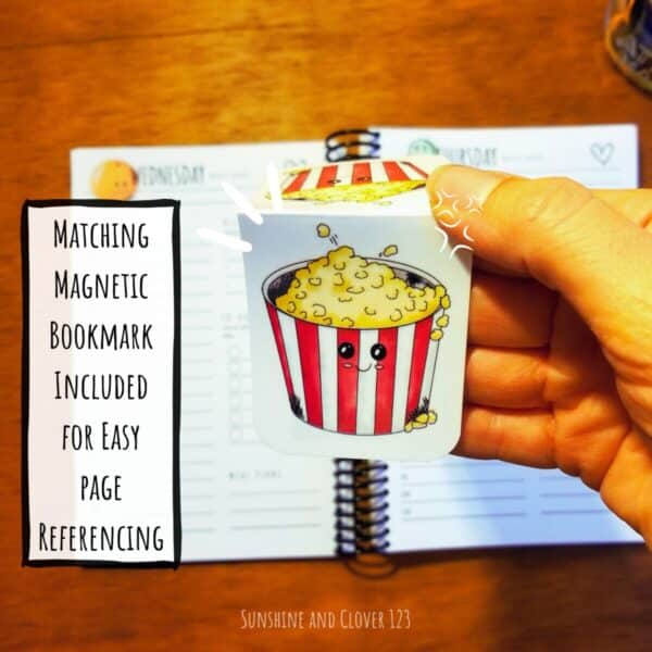 Matching magnetic bookmark is included with the daily planner for easy page referencing. The bookmark is of a little red and white popcorn bucket with popcorn flying out the top.