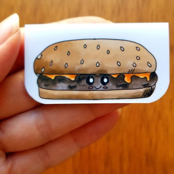 Cheeseburger bookmark has been hand illustrated and is shown being held.