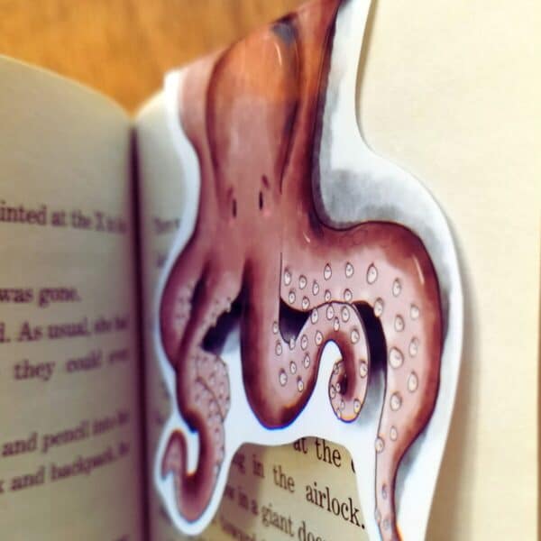 Magnetic bookmark is designed to look like an octopus draped over the pages.