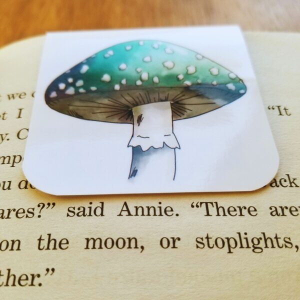 Mushroom bookmark comes in green with white spots.